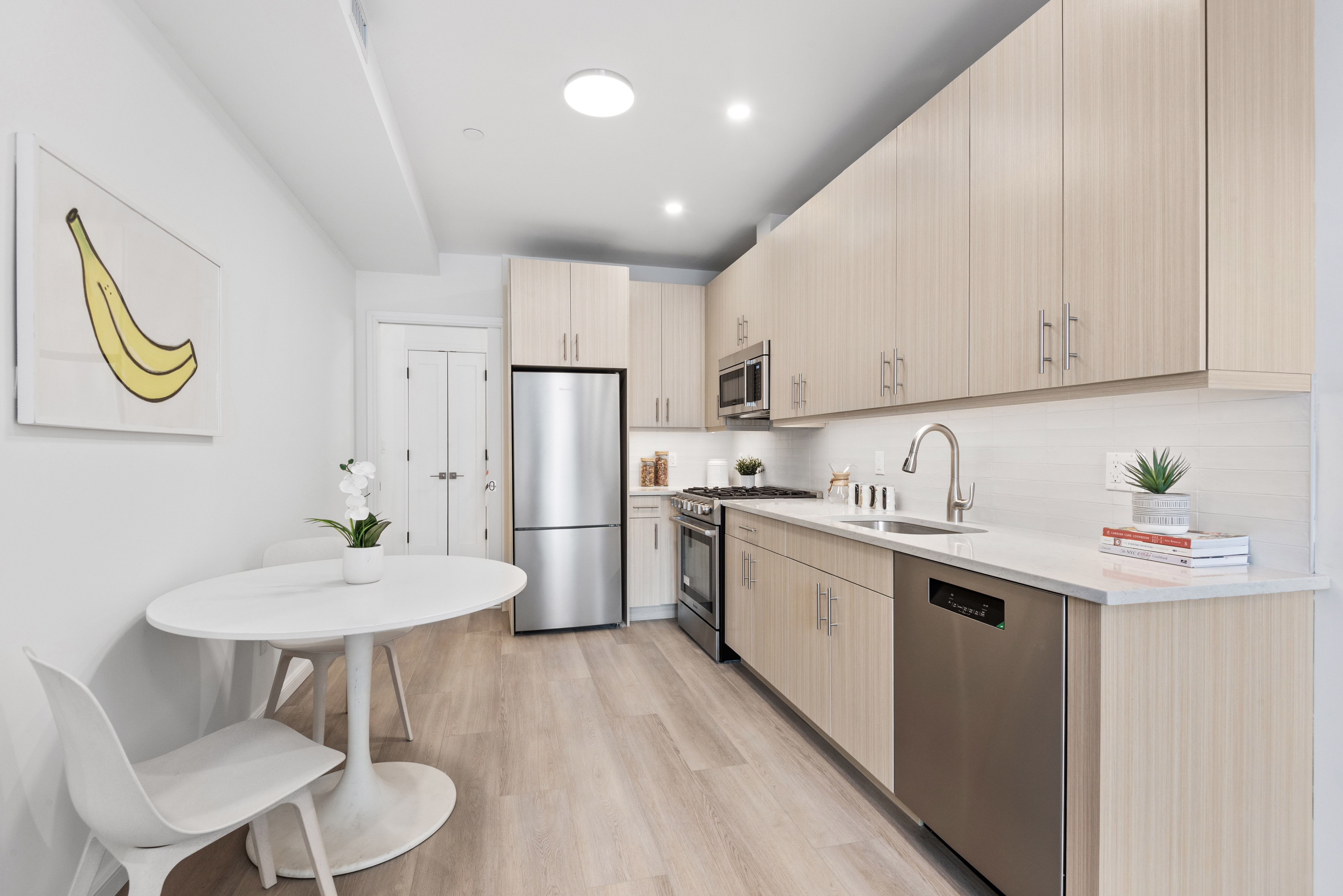 1 Lenox Road, Unit 2B Brooklyn, NY 11226 - Photo 5 of 6 a kitchen with stainless steel appliances granite countertop a sink a stove a refrigerator a dining table and chairs