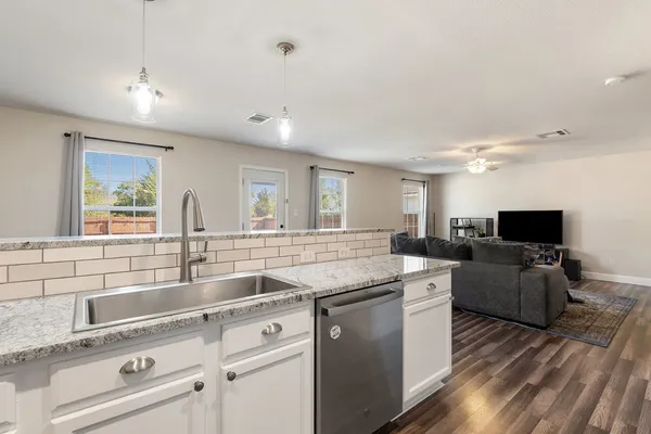 a kitchen with a sink stove and refrigerator