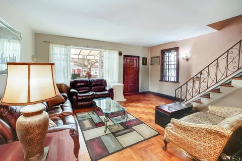 a living room with furniture rug and a window