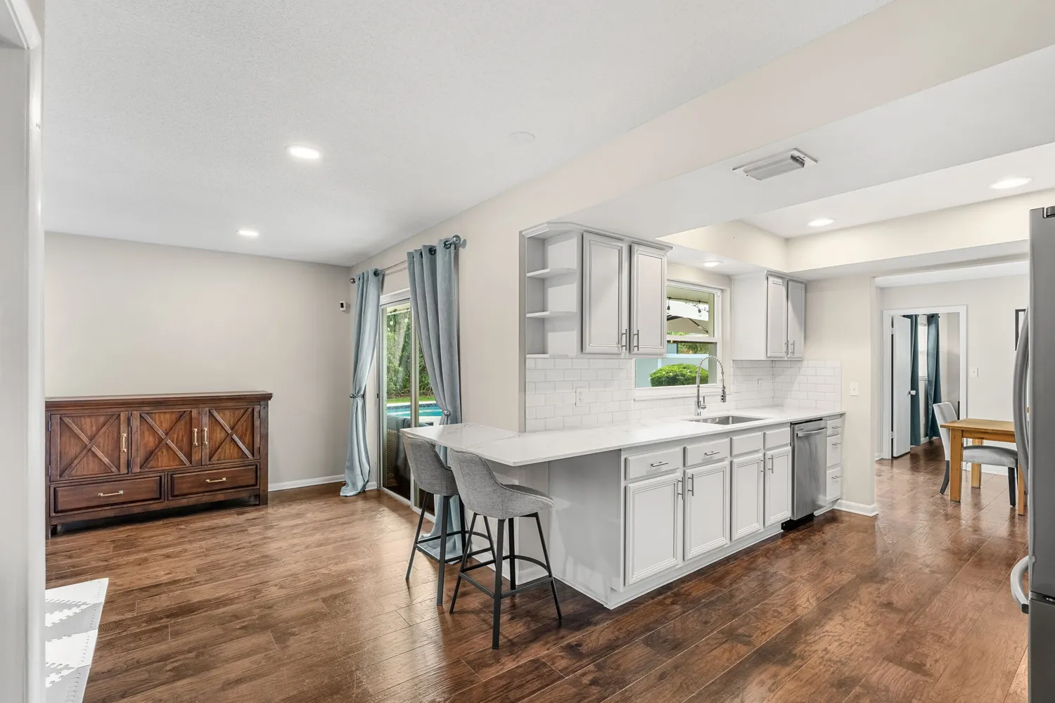 a kitchen with a sink and large window