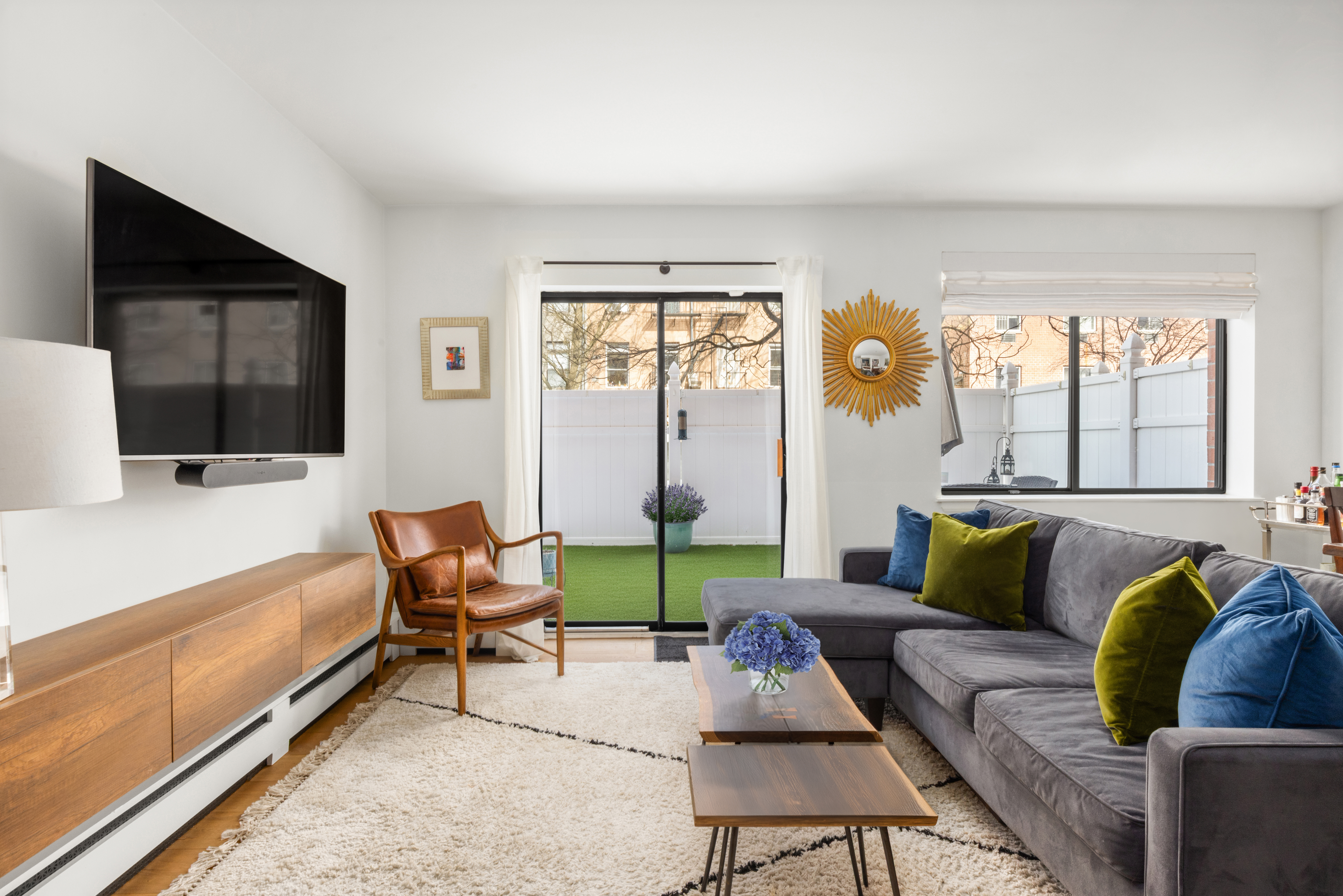333 East 119th Street, Unit 1H Manhattan, NY 10035 - Photo 6 of 17 a living room with furniture and a flat screen tv