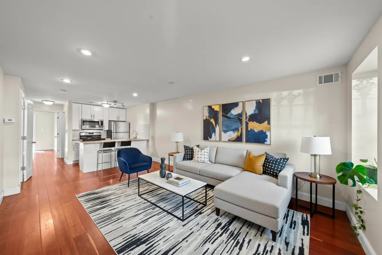 a living room with furniture and wooden floor