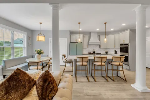 a view of a dining room with furniture and wooden floor