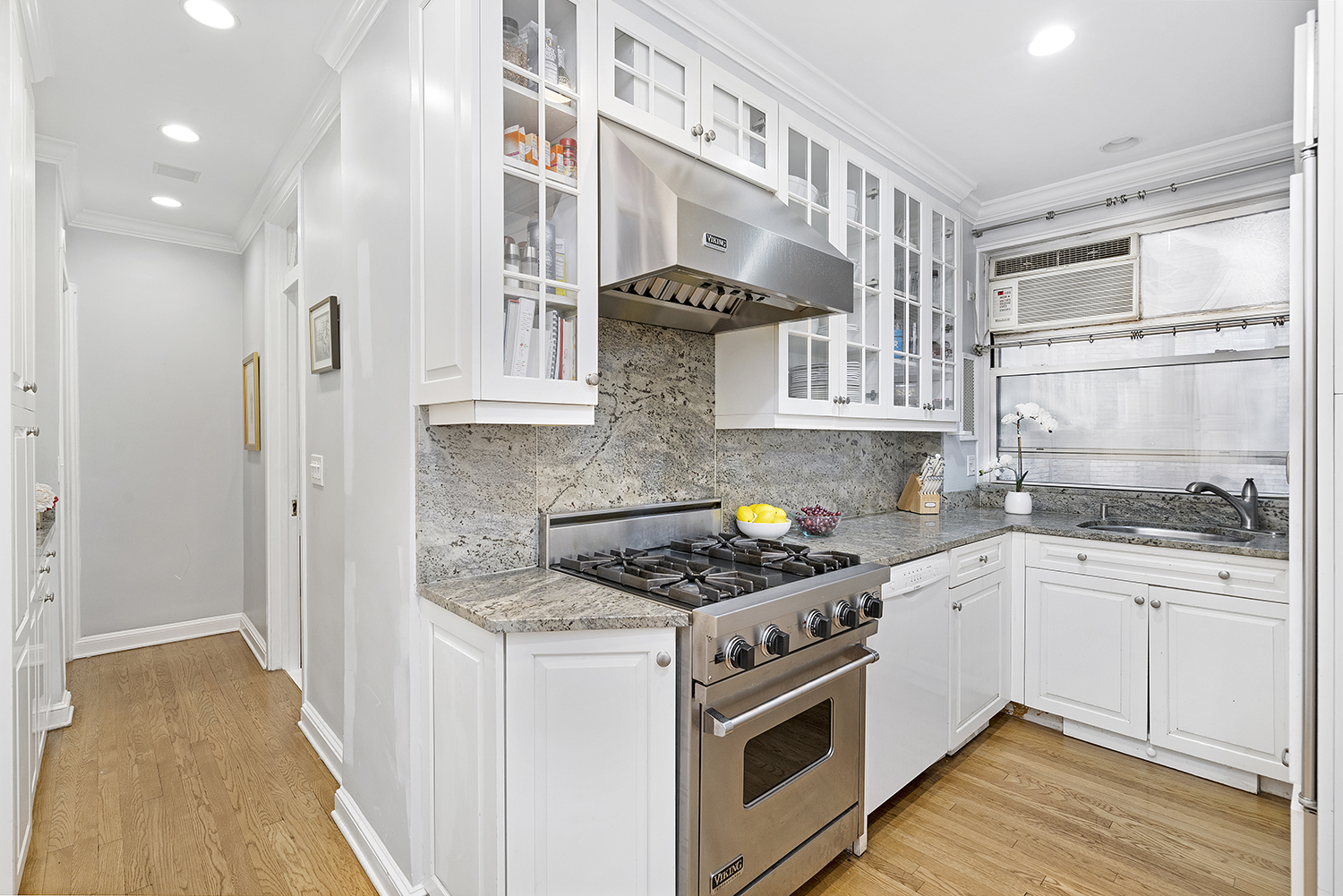 1045 Park Avenue, Unit 5A Manhattan, NY 10028 - Photo 6 of 10 a kitchen with stainless steel appliances granite countertop a stove and a sink