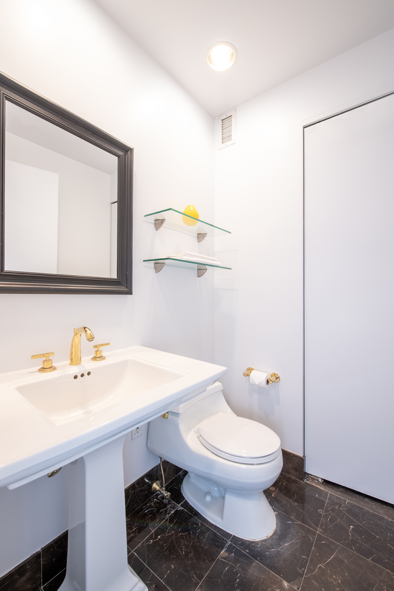 220 Riverside Boulevard, Unit 9K Manhattan, NY 10069 - Photo 7 of 8 a bathroom with a sink a toilet and mirror