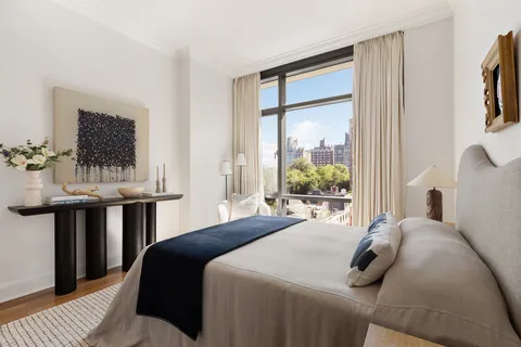 a bedroom with a bed and a table