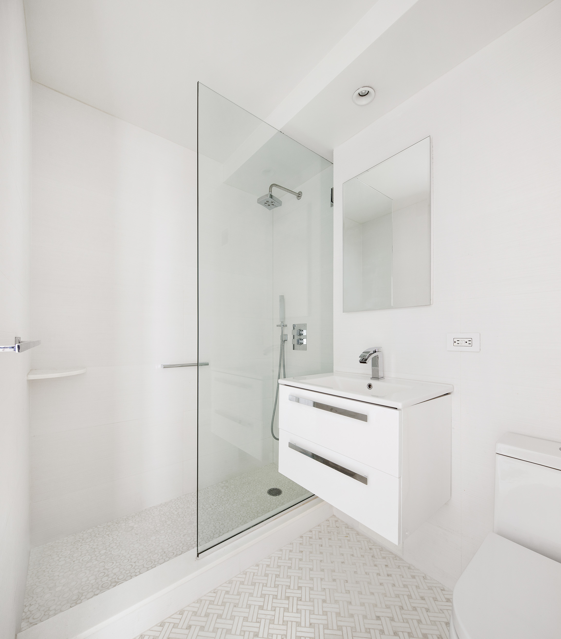 150 East 61st Street, Unit 7E Manhattan, NY 10065 - Photo 9 of 12 a bathroom with a sink a toilet and shower