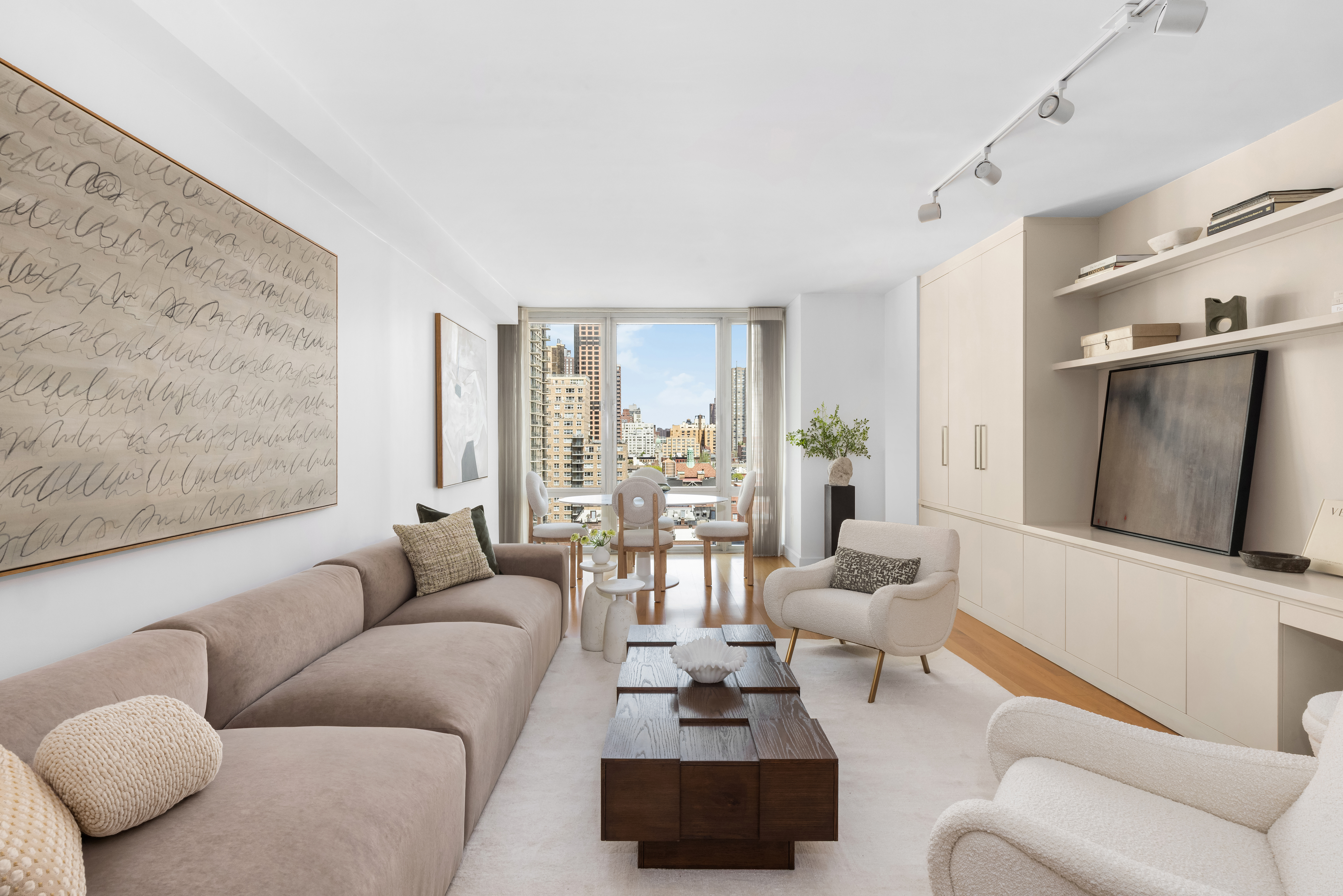 408 East 79th Street, Unit 14B Manhattan, NY 10075 - Photo 1 of 18 a living room with furniture and a flat screen tv