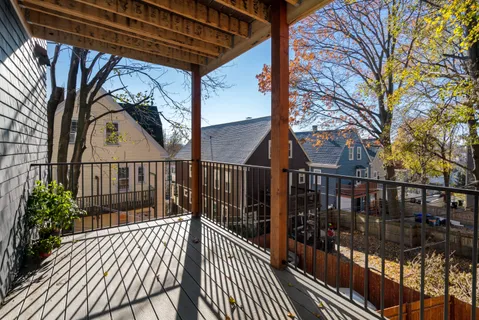 a view of balcony with wooden floor and fence