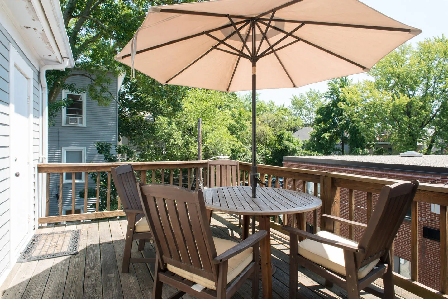 a view of balcony with furniture and umbrella