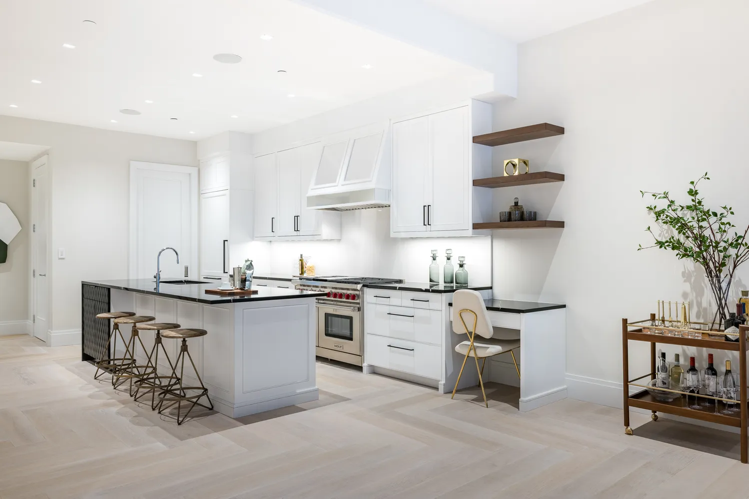 a kitchen with stainless steel appliances a sink a stove a refrigerator and cabinets