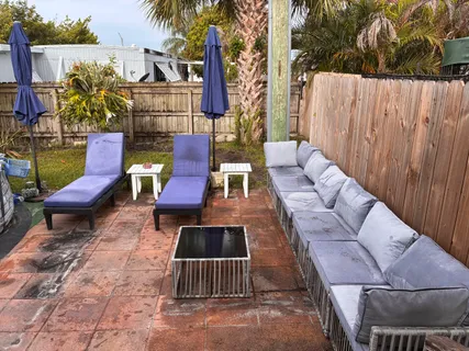 a view of a chairs and table in backyard