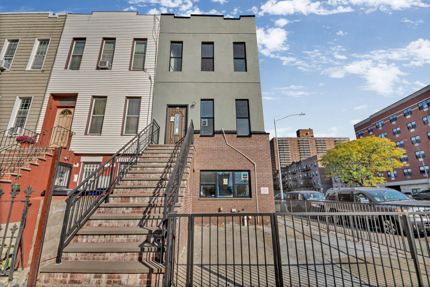 a view of a brick building next to a yard