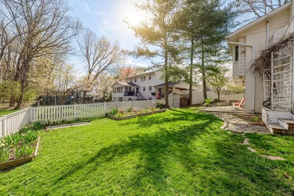 a view of a wooden chairs and table in the backyard