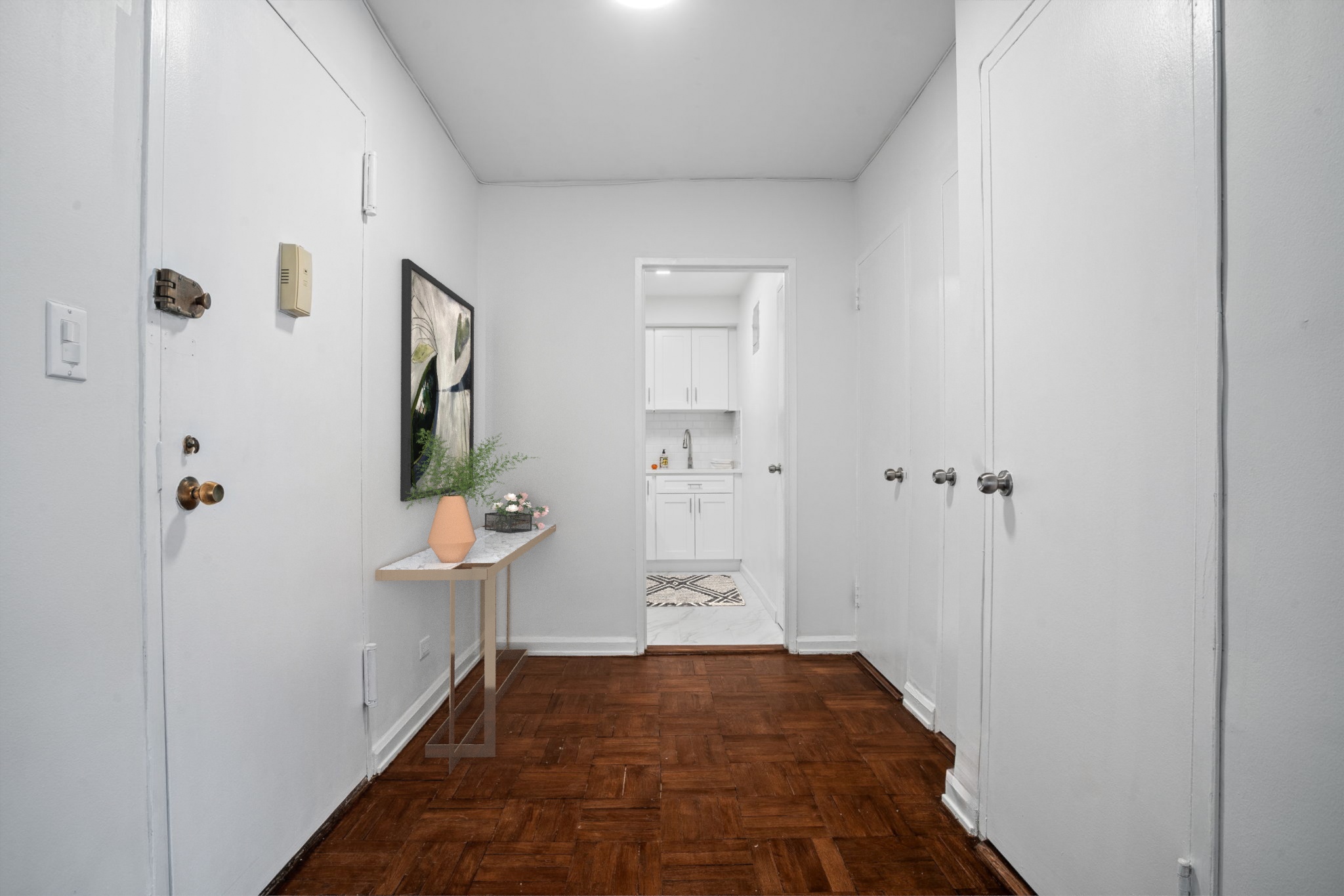 150 East 61st Street, Unit 8B Manhattan, NY 10065 - Photo 15 of 30 a view of a hallway with wooden floor and a bathroom