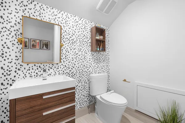 a bathroom with a sink mirror and toilet