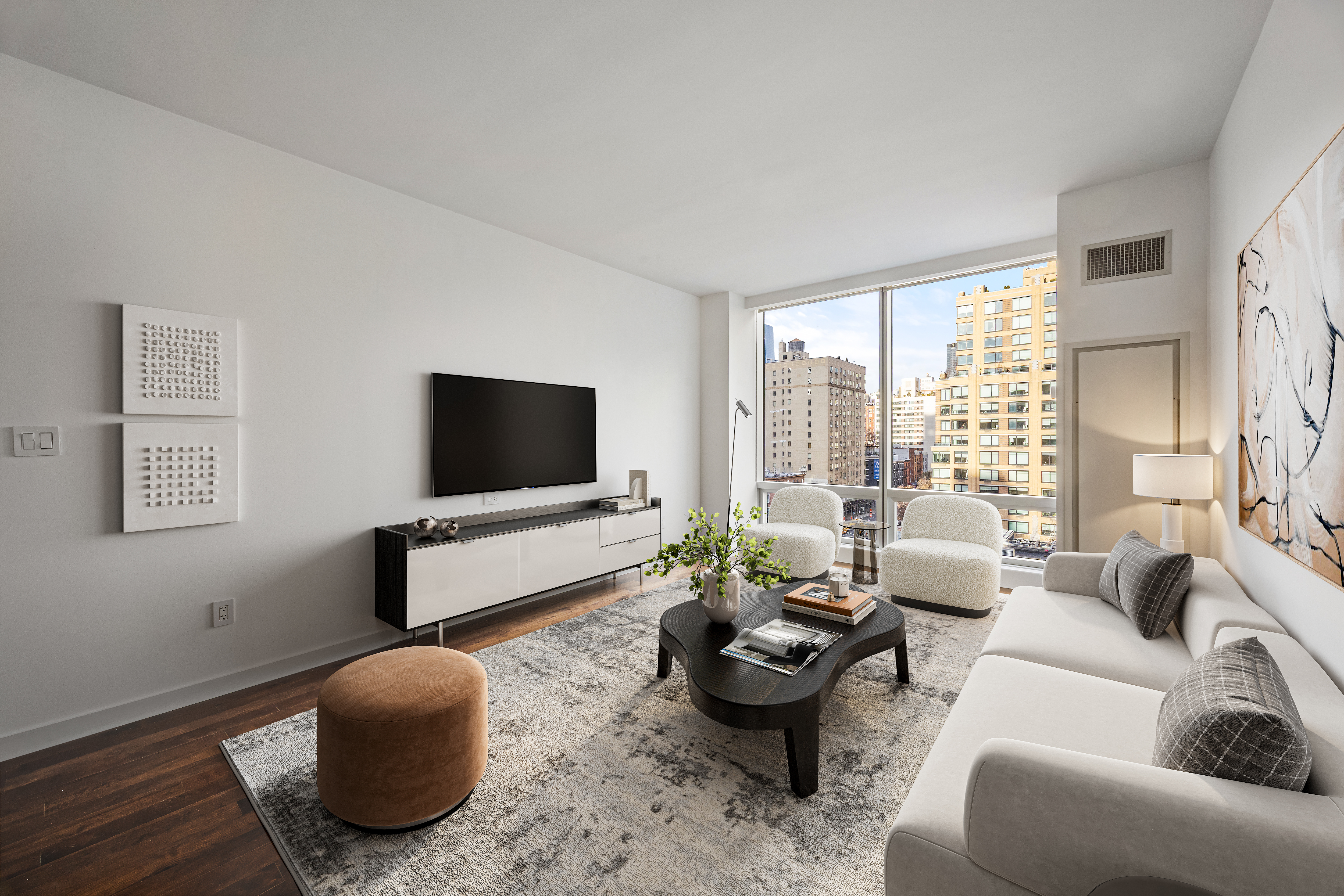 166 West 18th Street, Unit 7D Manhattan, NY 10011 - Photo 2 of 10 a living room with furniture and a flat screen tv
