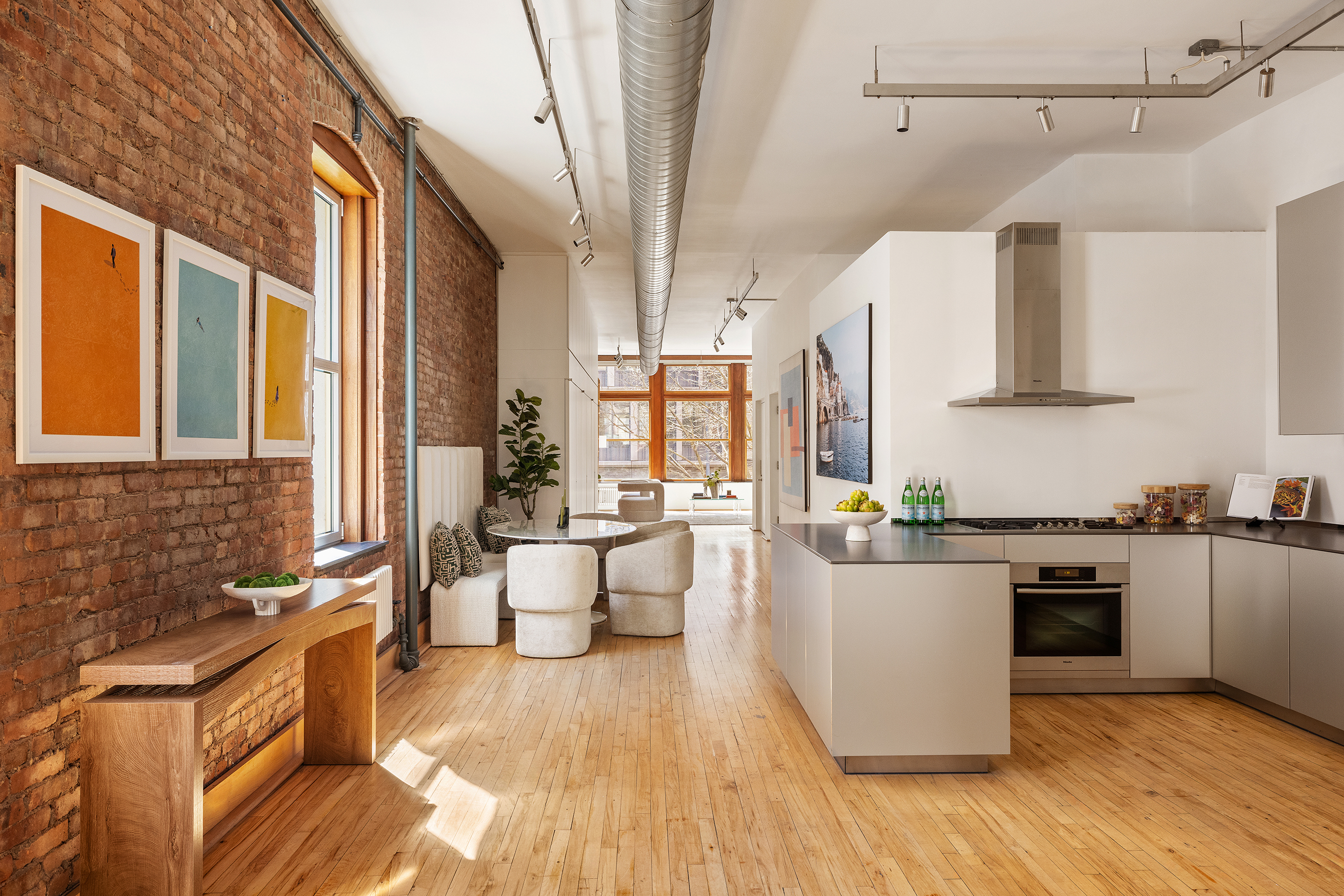 25 East 4th Street, Unit 2 Manhattan, NY 10003 - Photo 4 of 12 a kitchen with stainless steel appliances granite countertop a stove a sink and white cabinets with wooden floor