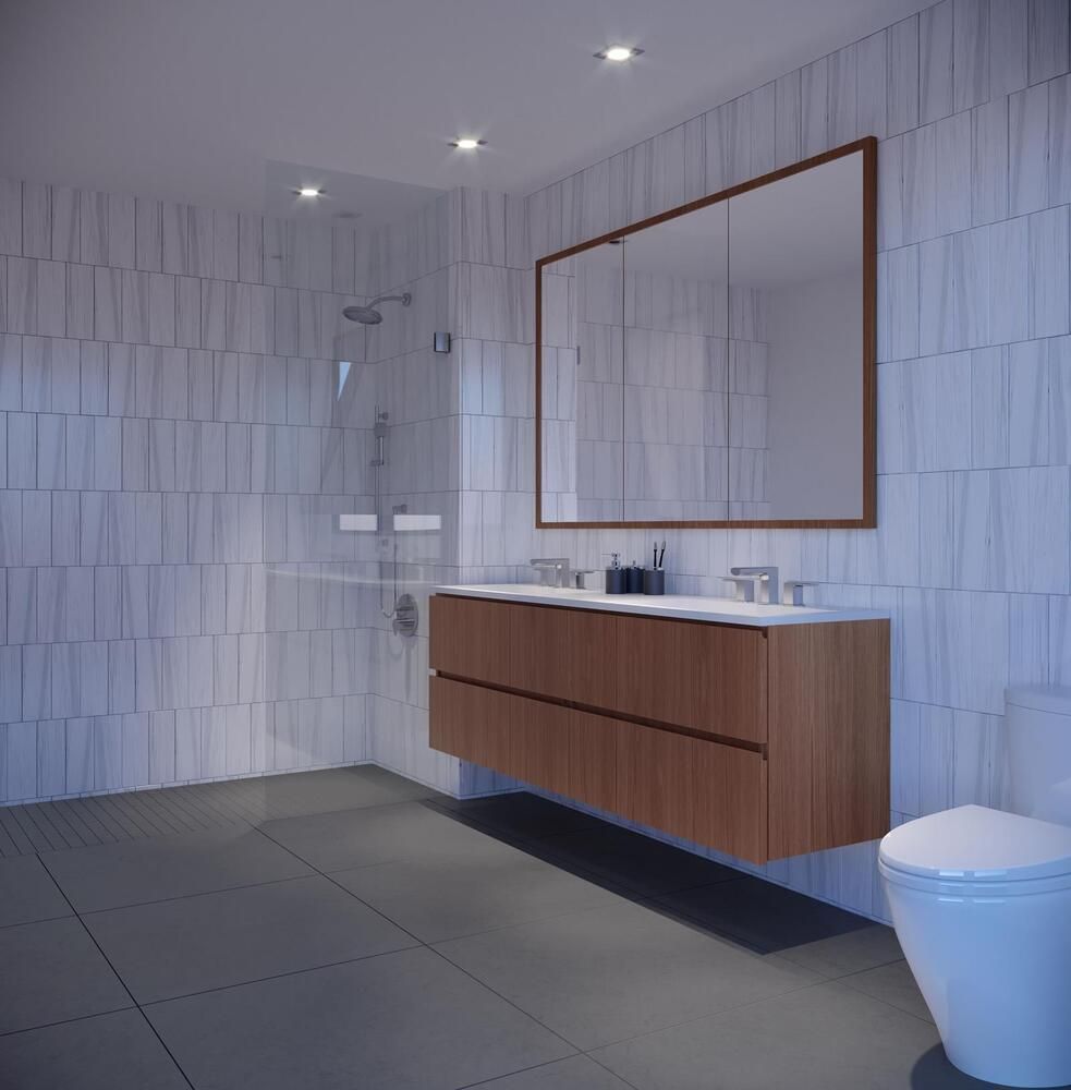 21-30 44th Drive, Unit 7D Queens, NY 11101 - Photo 5 of 14 a bathroom with a sink a toilet and mirror