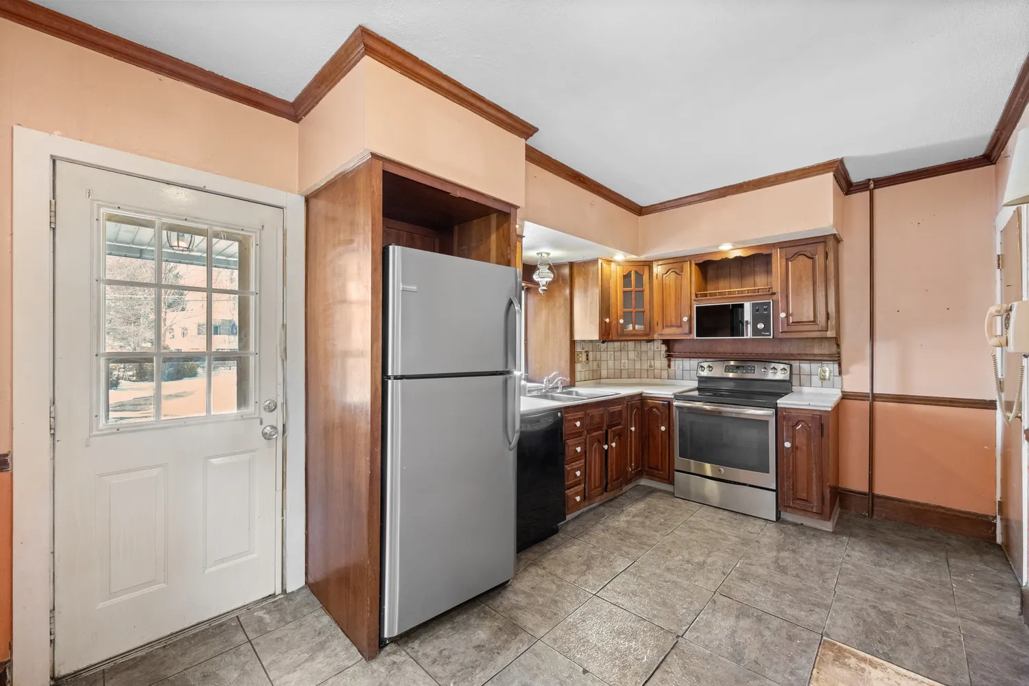 a kitchen with stainless steel appliances granite countertop a refrigerator stove and a sink