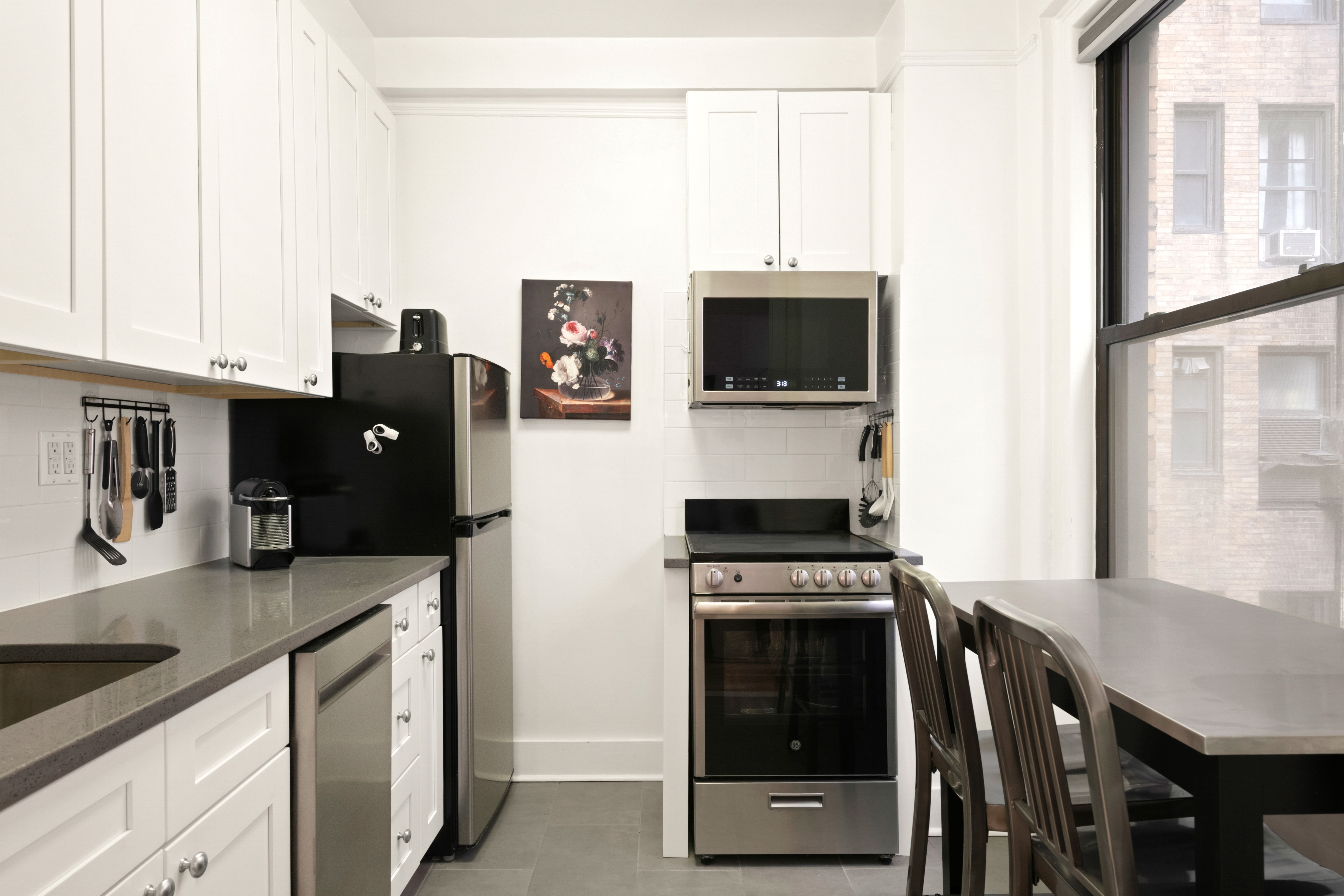 33 Riverside Drive, Unit 4D Manhattan, NY 10023 - Photo 4 of 9 a kitchen with stainless steel appliances a stove microwave and refrigerator