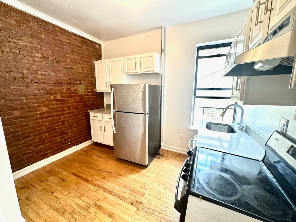 3694 Broadway, Unit 4F Manhattan, NY 10031 - Photo 1 of 4 a kitchen with a refrigerator and a stove