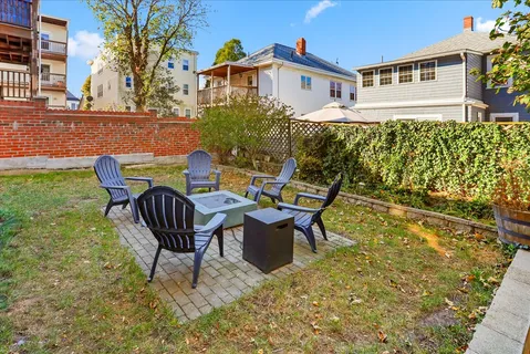 a view of a patio with table and chairs and potted plants