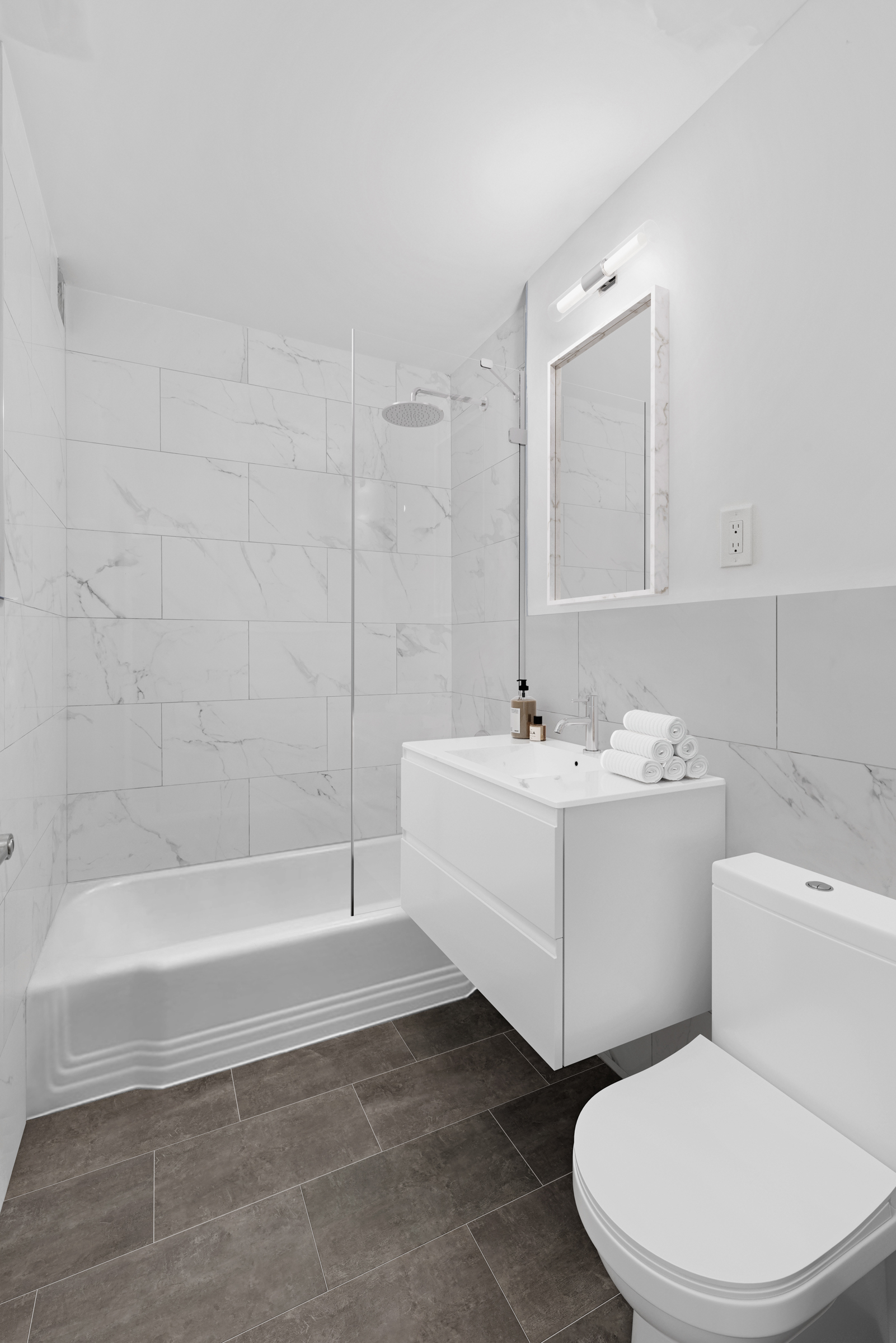315 East 65th Street, Unit 1A Manhattan, NY 10065 - Photo 5 of 12 a bathroom with a sink a toilet and bathtub
