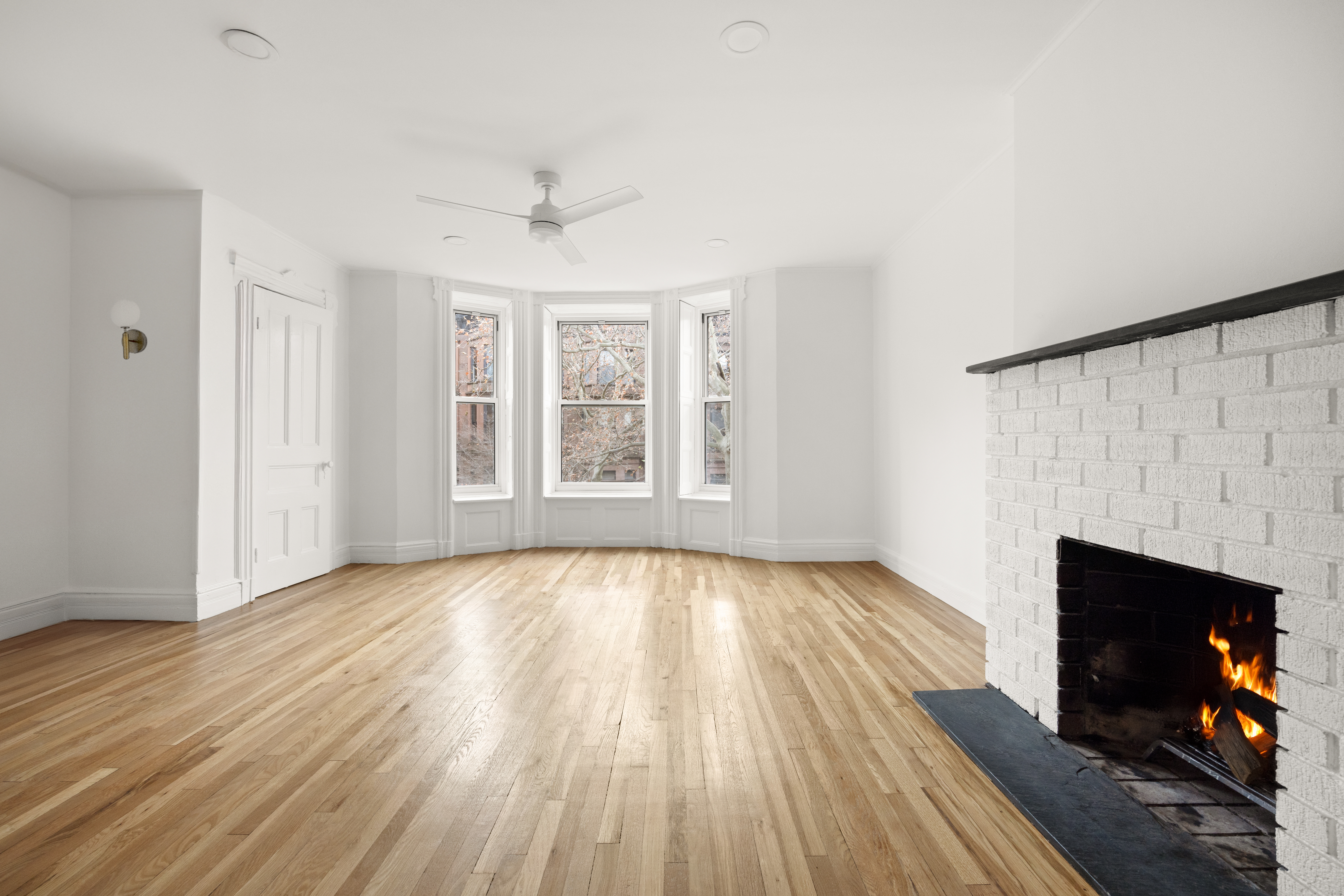 485 1st Street, Unit 2 Brooklyn, NY 11215 - Photo 2 of 17 an empty room with wooden floor fireplace and windows