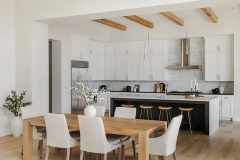 a kitchen with a table and chairs in it