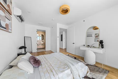 a bedroom with a bed and a chandelier