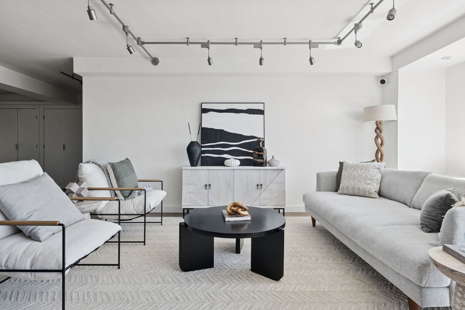 205 3rd Avenue, Unit 21H Manhattan, NY 10003 - Photo 4 of 17 a living room with furniture a rug and white walls