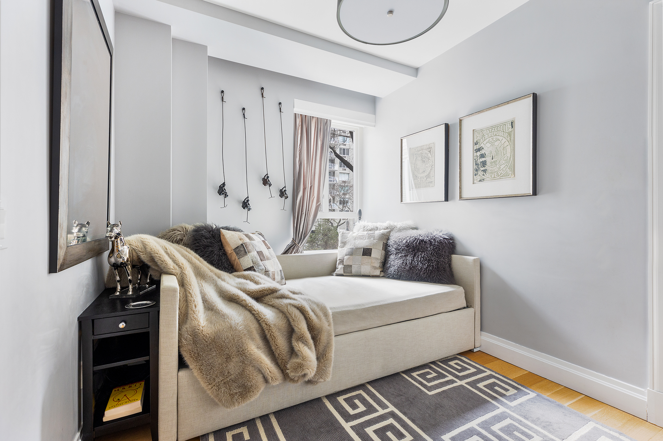 200 East 66th Street, Unit E207 Manhattan, NY 10065 - Photo 9 of 12 a bed room with a bed and a window