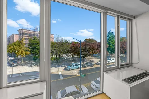 a room with a large window and pool table