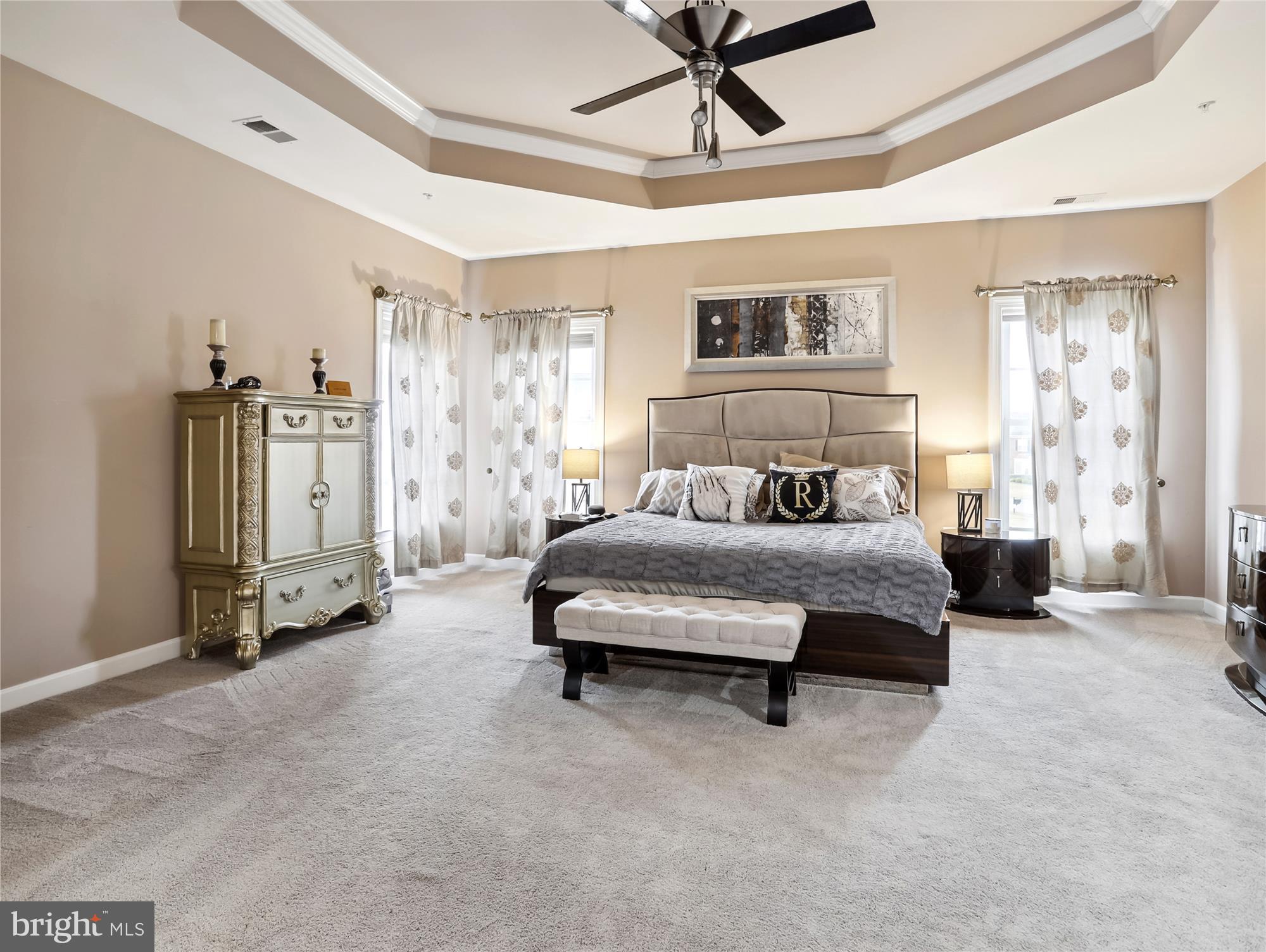 14302 Derby Ridge Road Bowie, MD 20721 - Photo 44 of 67 a spacious bedroom with a bed a couch and a chandelier