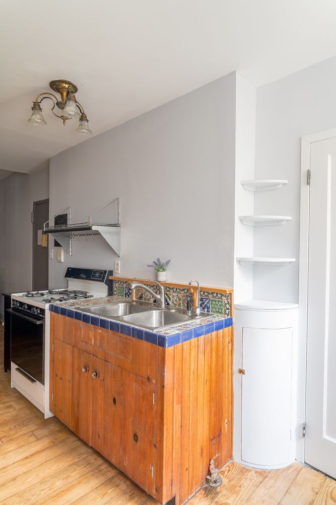 a kitchen with granite countertop a sink stainless steel appliances and cabinets