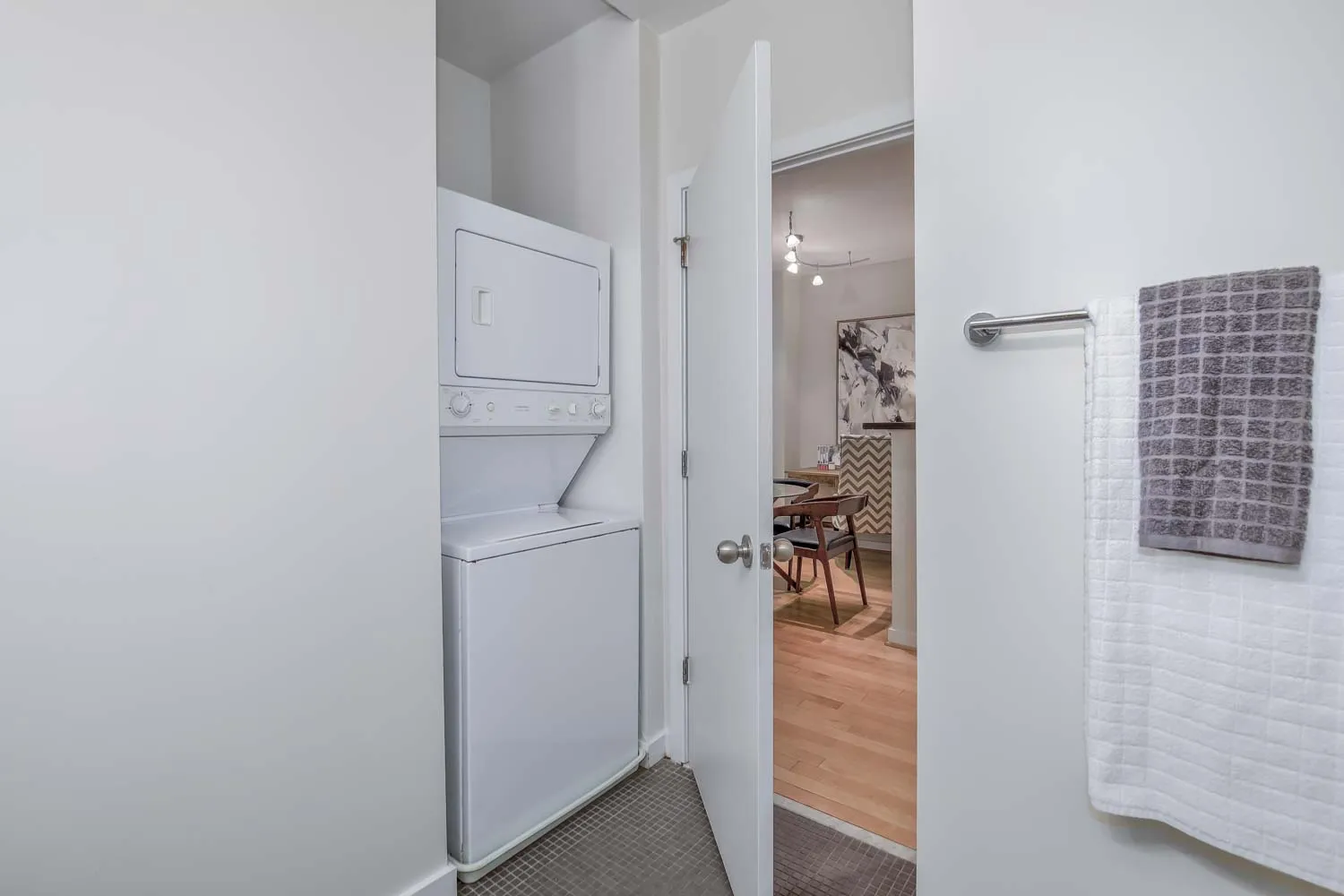 a view of a hallway with dining room and closet