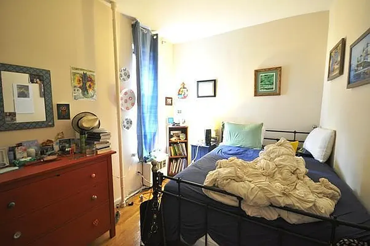 416 East 71st Street, Unit 21 Manhattan, NY 10021 - Photo 3 of 5 a bedroom with furniture and a window