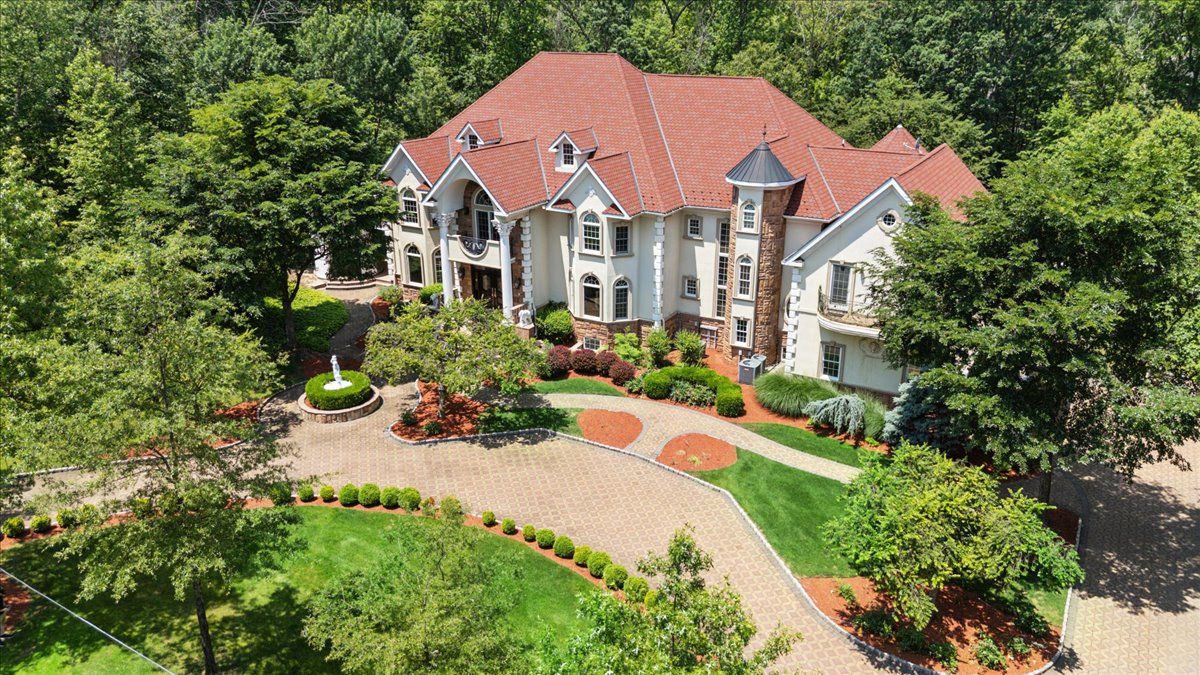 a front view of a house with a yard garden and outdoor seating