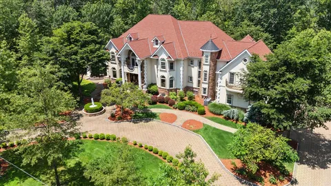 a front view of a house with a yard garden and outdoor seating