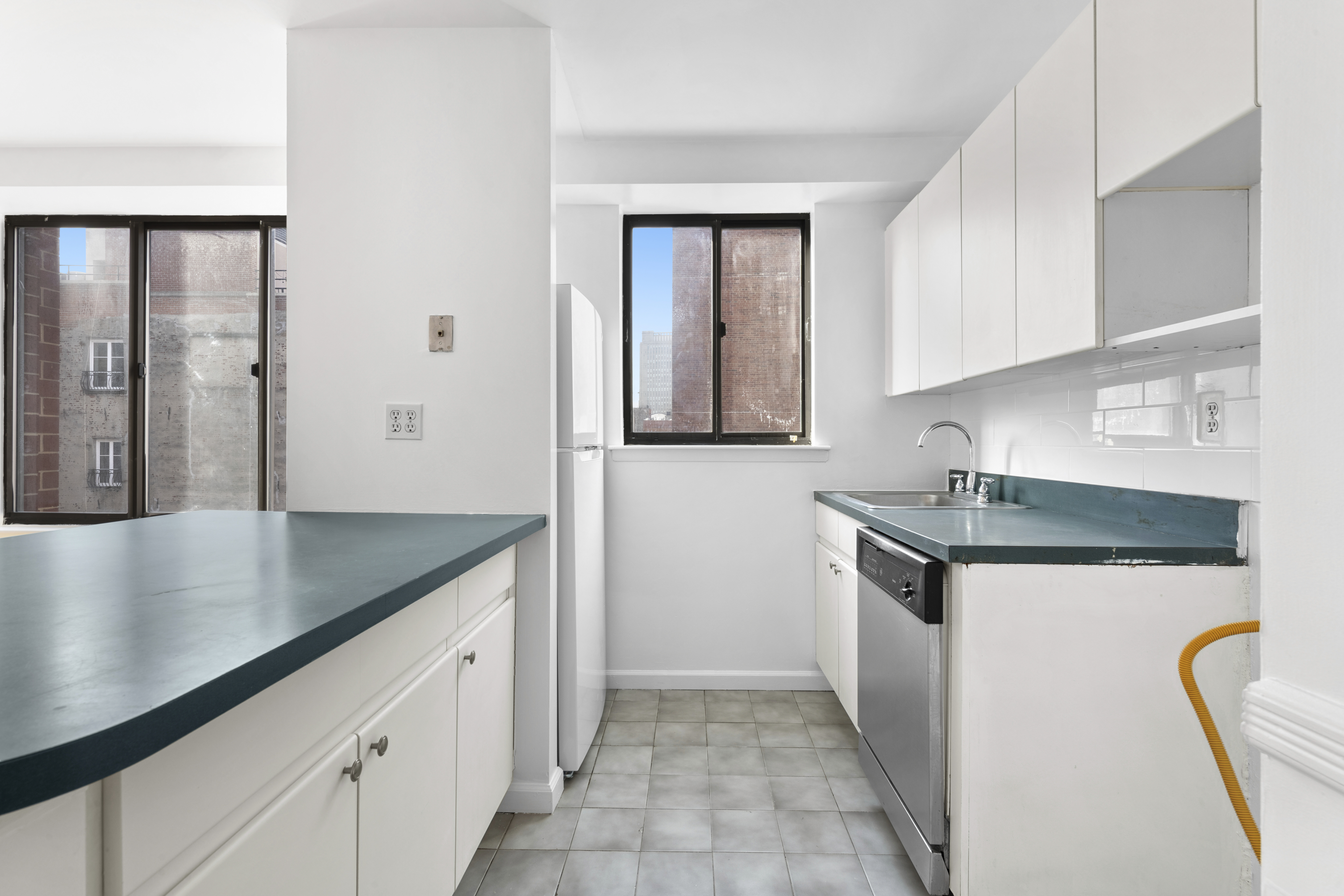 179 Grand Street, Unit 6G Manhattan, NY 10013 - Photo 6 of 8 a kitchen with stainless steel appliances granite countertop a sink a stove and a refrigerator