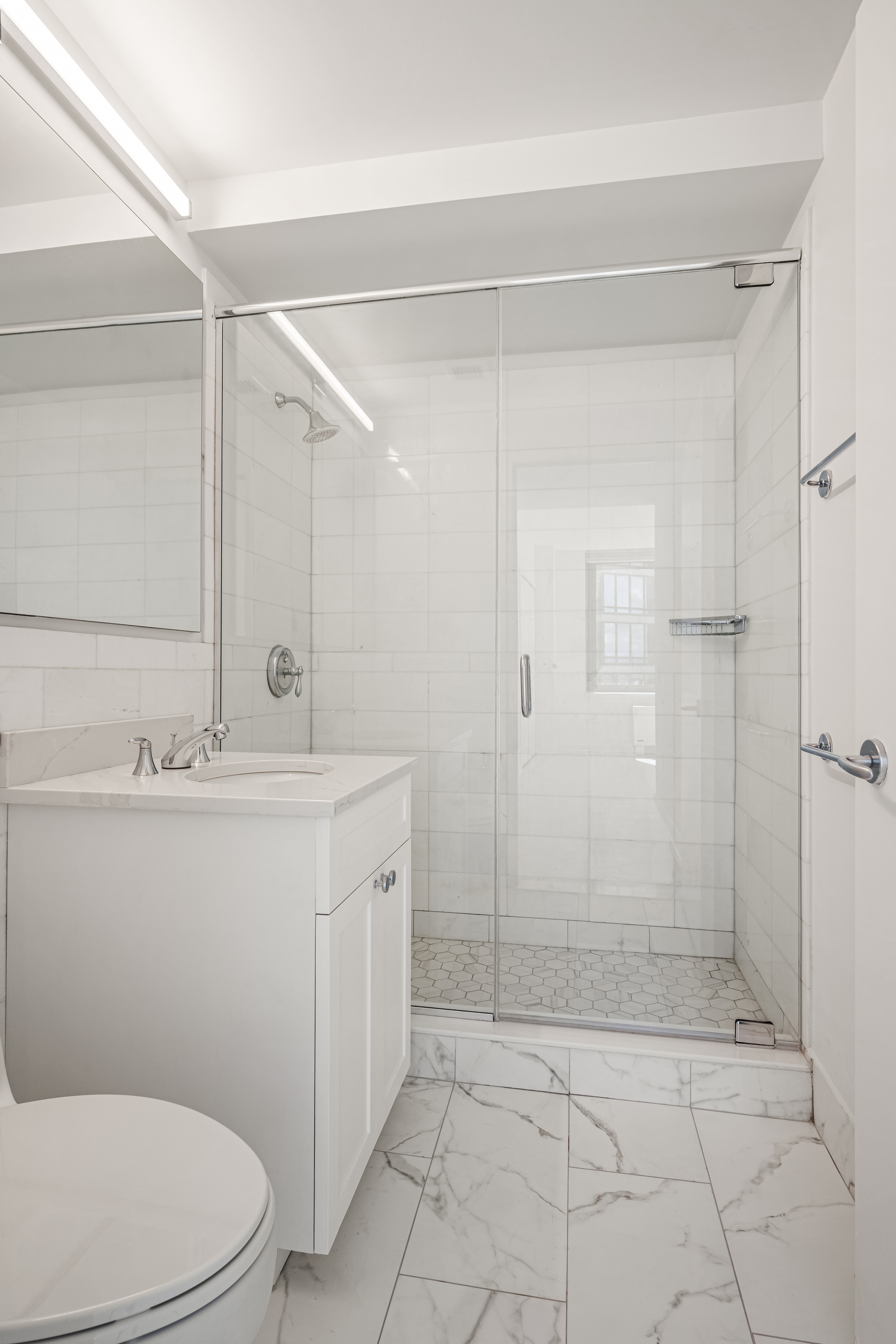 230 Ashland Place, Unit 19D Brooklyn, NY 11217 - Photo 4 of 11 a bathroom with a sink a toilet and shower