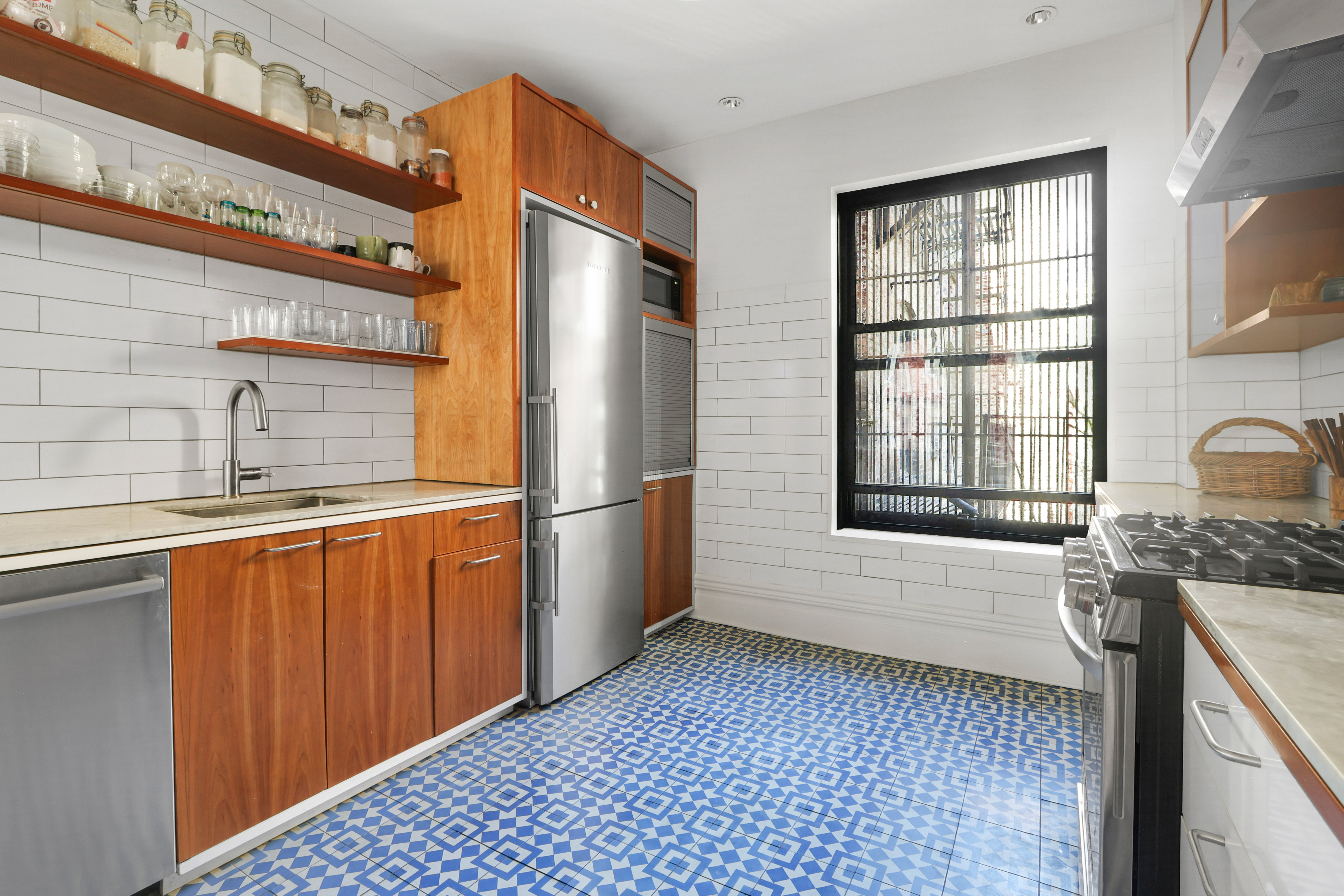 311 West 97th Street, Unit 6E Manhattan, NY 10025 - Photo 10 of 18 a kitchen with stainless steel appliances granite countertop a refrigerator a sink dishwasher a stove and white countertops with wooden floor