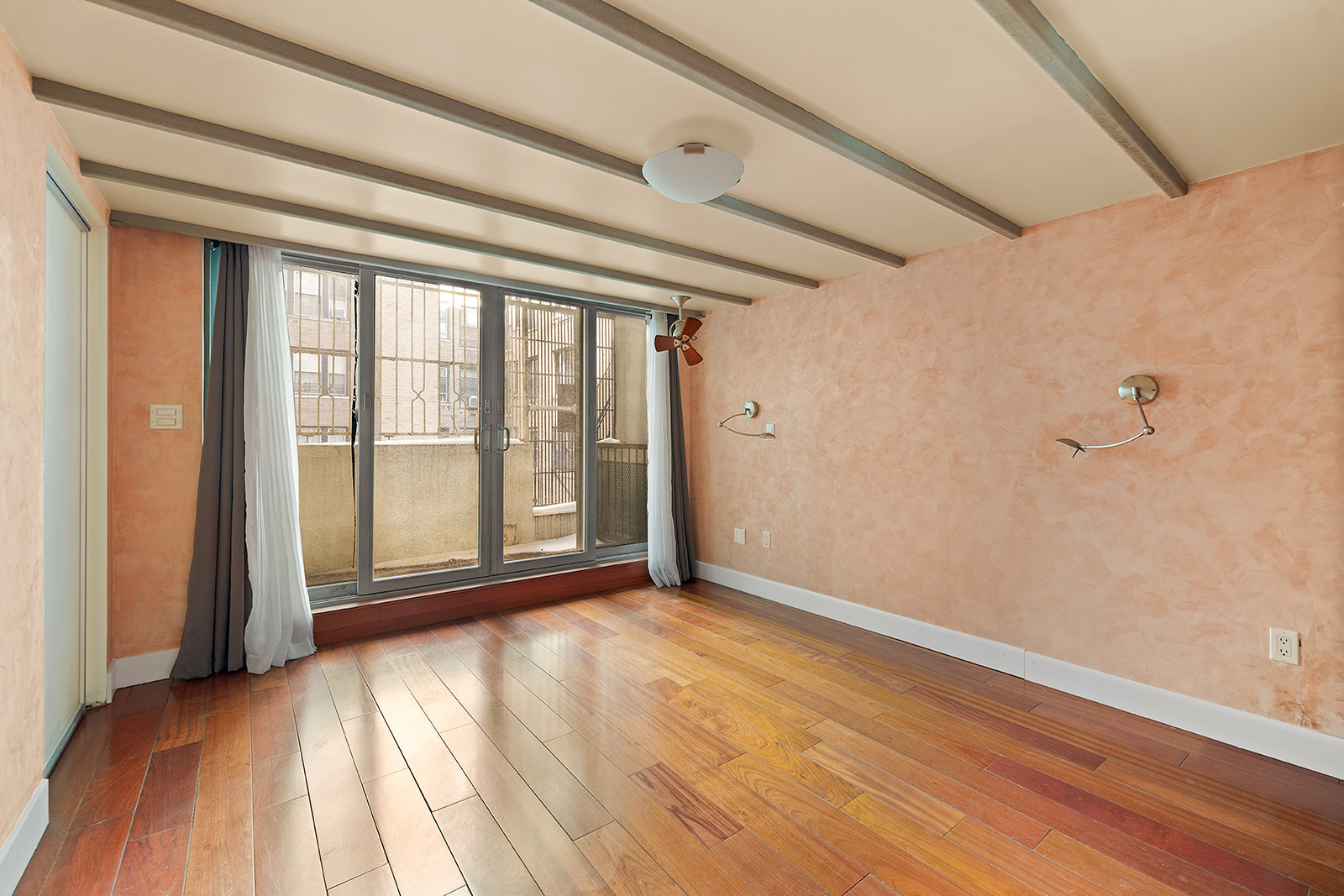 257 West 93rd Street, Unit 2B Manhattan, NY 10025 - Photo 5 of 6 a view of empty room with wooden floor and fan