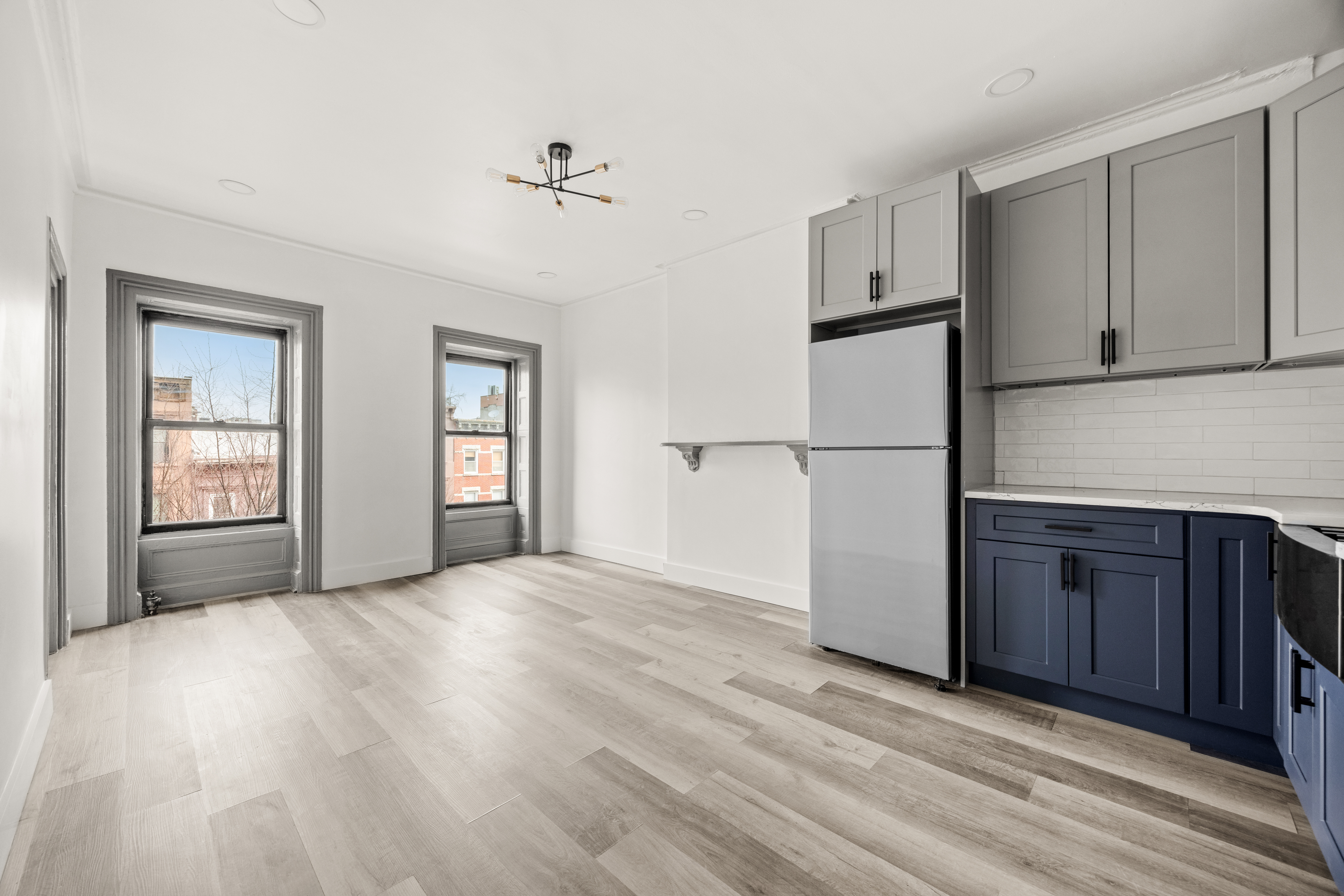 126 Quincy Street, Unit 3 Brooklyn, NY 11216 - Photo 6 of 11 a view of an empty room with a kitchen and a window