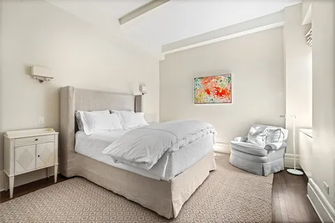 a spacious bedroom with a bed and a couch