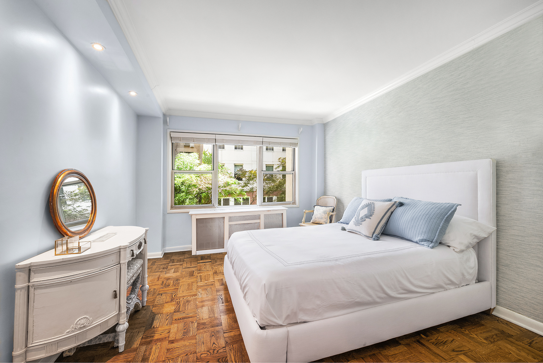 311 East 71st Street, Unit 2B Manhattan, NY 10021 - Photo 8 of 10 a bedroom with a bed and a clock on dresser