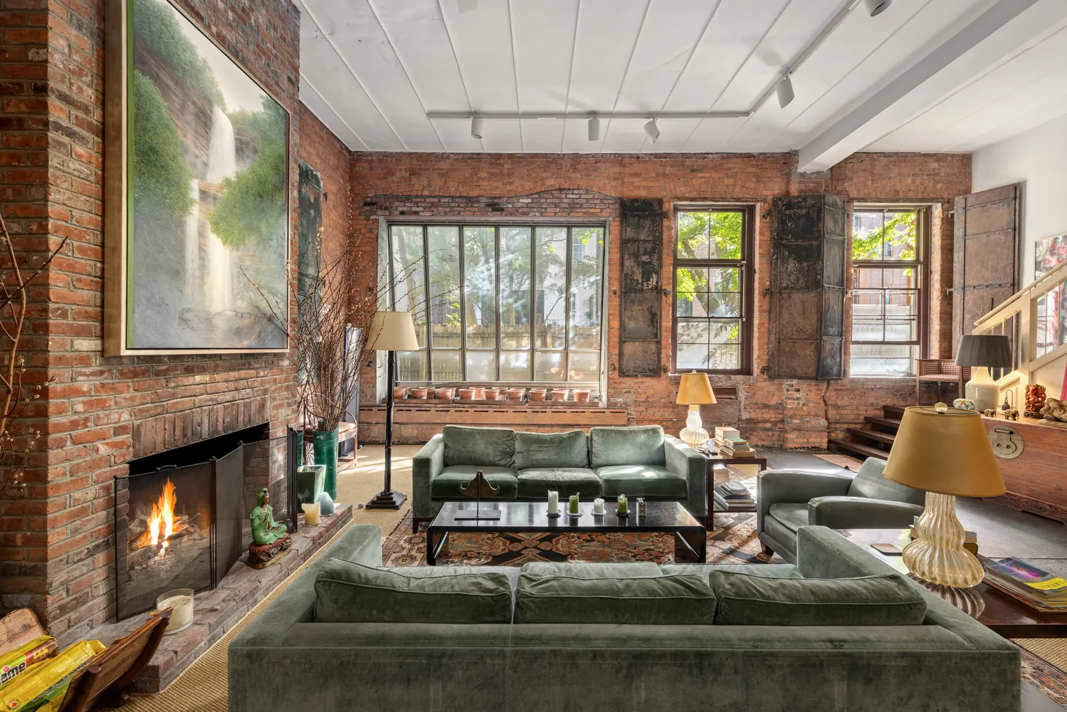 a living room with fireplace furniture and a fireplace