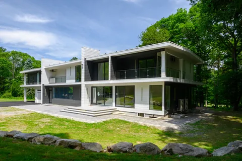 a view of a house with swimming pool and porch