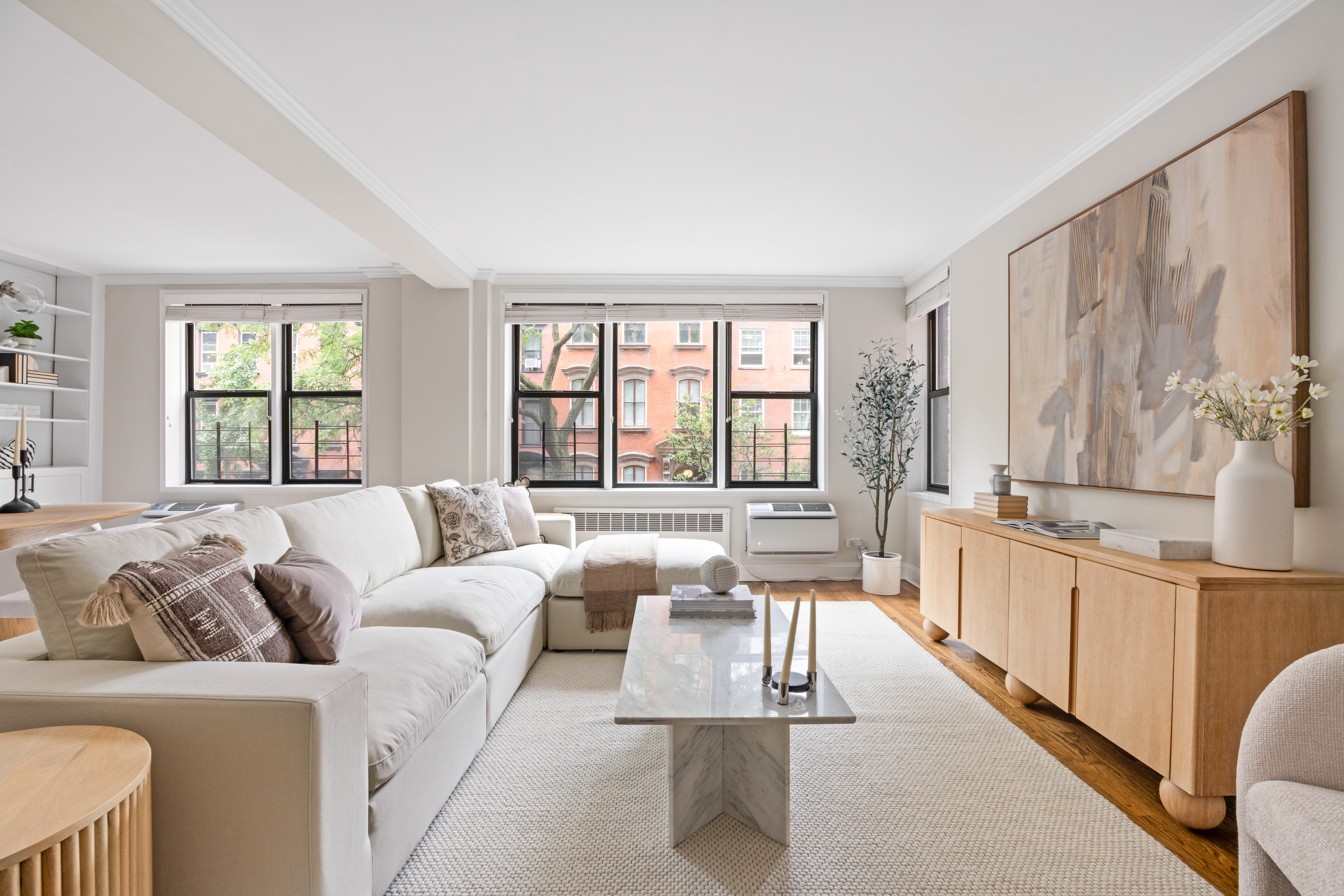 211 East 18th Street, Unit 2O Manhattan, NY 10003 - Photo 3 of 14 a large living room with furniture and a large window